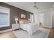 This bedroom features a ceiling fan, a patterned rug, and a stylish accent wall at 815 Laurelwood Dr, Durham, NC 27705