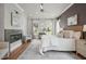 This bedroom features a fireplace, a patterned rug, and natural light from the windows at 815 Laurelwood Dr, Durham, NC 27705