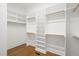 Walk-in closet with custom shelves and wooden rails at 815 Laurelwood Dr, Durham, NC 27705