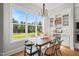 Cozy dining area with backyard views from a large window and a modern light fixture at 815 Laurelwood Dr, Durham, NC 27705