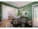 This dining room features hardwood floors, a large table, and a modern light fixture, perfect for entertaining at 815 Laurelwood Dr, Durham, NC 27705