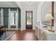 Elegant entryway with wood floors, a dark front door, and a white console table with decorative accents at 815 Laurelwood Dr, Durham, NC 27705