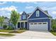 Charming home featuring a blue exterior, well-kept lawn, and a convenient two-car garage at 815 Laurelwood Dr, Durham, NC 27705