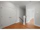 Hallway featuring wooden floors, neutral walls, and double doors to a closet at 815 Laurelwood Dr, Durham, NC 27705