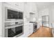 Modern kitchen features stainless steel appliances, white cabinets, and a stylish backsplash at 815 Laurelwood Dr, Durham, NC 27705