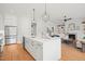 Spacious kitchen featuring a large island, stainless steel appliances and hardwood flooring throughout at 815 Laurelwood Dr, Durham, NC 27705