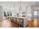 Large kitchen with an island that includes bar stool seating with statement pendant lighting above at 815 Laurelwood Dr, Durham, NC 27705