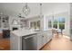 Open concept kitchen and living room with large island, modern pendant lighting, and stainless steel appliances at 815 Laurelwood Dr, Durham, NC 27705