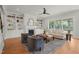 Bright living room with built-in bookshelves, fireplace, ceiling fan, and access to a screened porch at 815 Laurelwood Dr, Durham, NC 27705