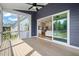 Inviting screened-in porch with wood flooring and ceiling fan, overlooking the backyard and seamlessly flowing into the living space at 815 Laurelwood Dr, Durham, NC 27705