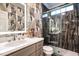 Modern bathroom with a glass-enclosed shower, elegant vanity, and chic wallpaper, providing a luxurious experience at 815 Marlowe Rd # 10, Raleigh, NC 27609