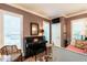 Inviting bedroom with neutral walls, shutters, piano, and a comfortable daybed, creating a versatile space at 815 Marlowe Rd # 10, Raleigh, NC 27609