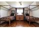 Charming bedroom featuring two canopy beds, wood floors, and window with natural light at 815 Marlowe Rd # 10, Raleigh, NC 27609