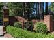 Elegant community entrance with brick signage and manicured landscaping, providing privacy at 815 Marlowe Rd # 10, Raleigh, NC 27609