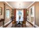 Formal dining room featuring a long table, chandelier, and decorative window treatments for sophisticated gatherings at 815 Marlowe Rd # 10, Raleigh, NC 27609