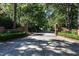 Spacious driveway and entrance with brick pillars, greenery, and signage for a private drive at 815 Marlowe Rd # 10, Raleigh, NC 27609