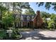 Charming brick home with mature landscaping, dormer windows, and a prominent chimney, showcasing classic architectural details at 815 Marlowe Rd # 10, Raleigh, NC 27609