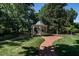 Picturesque gazebo surrounded by lush landscaping and a brick path, perfect for outdoor relaxation at 815 Marlowe Rd # 10, Raleigh, NC 27609