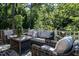 Relaxing outdoor seating area with wicker furniture, plush cushions and lush green surroundings at 815 Marlowe Rd # 10, Raleigh, NC 27609