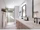 Stylish bathroom features double vanity, modern fixtures, and glass-enclosed shower for a spa-like experience at 1017 N Buchanan Blvd # C, Durham, NC 27701