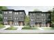 Charming townhomes feature modern design, gray siding, brick accents, and well-manicured landscaping for curb appeal at 1017 N Buchanan Blvd # C, Durham, NC 27701