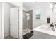 Modern bathroom features a glass-enclosed shower, vanity with a sink, and a window for natural light at 1025 Quindell Dr, Holly Springs, NC 27540