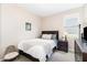 Well-lit bedroom features neutral tones, a comfortable bed, and a convenient bedside table at 1025 Quindell Dr, Holly Springs, NC 27540