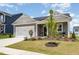 Charming single-Gathering home with a well-manicured lawn and a two-car garage at 1025 Quindell Dr, Holly Springs, NC 27540
