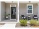 Inviting front porch featuring a cozy seating area and stylish decor at 1025 Quindell Dr, Holly Springs, NC 27540