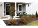 Charming front porch with decorative bushes and room for seating at 1025 Quindell Dr, Holly Springs, NC 27540