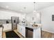 Bright kitchen with stainless steel appliances and a central island at 1025 Quindell Dr, Holly Springs, NC 27540