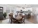 Bright eat-in kitchen features white cabinetry, stainless appliances, and a granite-topped island with bar seating at 1025 Quindell Dr, Holly Springs, NC 27540