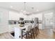 Kitchen island with seating area, open concept dining room in background at 1025 Quindell Dr, Holly Springs, NC 27540