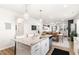 Bright, modern kitchen with a large island, open to the dining and living areas at 1025 Quindell Dr, Holly Springs, NC 27540