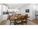 Open-concept kitchen and dining area featuring stainless appliances, white cabinetry, and a stylish backsplash at 1025 Quindell Dr, Holly Springs, NC 27540