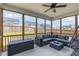 Screened patio featuring a comfortable sectional, ceiling fan, and a view of the backyard at 1025 Quindell Dr, Holly Springs, NC 27540