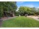Lush backyard featuring a play area, cornhole setup, shed, fire pit, and well-maintained lawn at 10513 Cardington Ln, Raleigh, NC 27614