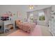 Bright bedroom with a plush rug, large windows, and cheerful decor at 10513 Cardington Ln, Raleigh, NC 27614