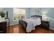 Cozy bedroom featuring hardwood floors, natural light, and neutral wall colors for a relaxing ambiance at 10513 Cardington Ln, Raleigh, NC 27614