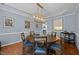 Dining room with a round table, hardwood floors, and elegant light fixture at 10513 Cardington Ln, Raleigh, NC 27614