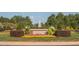 Beautifully landscaped entrance to the community with a water feature and colorful flower beds at 10513 Cardington Ln, Raleigh, NC 27614
