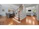 Elegant foyer featuring a staircase, hardwood floors, and views into the dining room and living room areas at 10513 Cardington Ln, Raleigh, NC 27614
