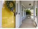 Inviting front entrance featuring a bright yellow door adorned with a decorative wreath and black-and-white ribbon at 10513 Cardington Ln, Raleigh, NC 27614