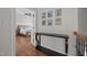 Hallway with hardwood floors and a view of a main bedroom at 10513 Cardington Ln, Raleigh, NC 27614