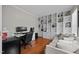 Comfortable home office featuring built-in bookshelves, hardwood floors, a desk, and a seating area with a couch at 10513 Cardington Ln, Raleigh, NC 27614
