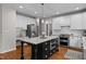 Bright kitchen featuring granite countertops, stainless steel appliances, and center island at 10513 Cardington Ln, Raleigh, NC 27614
