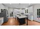 Bright kitchen featuring granite countertops, stainless steel appliances, and center island at 10513 Cardington Ln, Raleigh, NC 27614