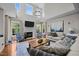 Spacious living room with fireplace, high ceilings, large windows, and stylish furnishings at 10513 Cardington Ln, Raleigh, NC 27614