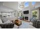Bright living room with fireplace, high ceilings, large windows, and hardwood floors at 10513 Cardington Ln, Raleigh, NC 27614