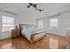 Spacious main bedroom with hardwood floors, natural light, ceiling fan, and decorative wall panels at 10513 Cardington Ln, Raleigh, NC 27614
